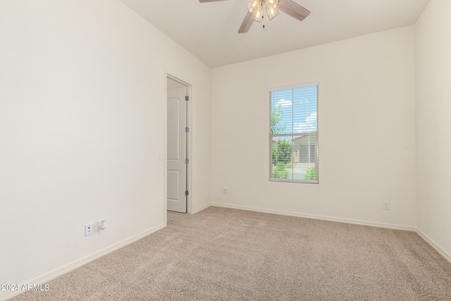 carpeted spare room with ceiling fan