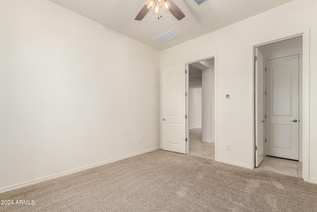 unfurnished bedroom featuring lofted ceiling, light carpet, and ceiling fan