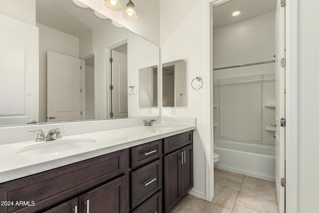 full bathroom featuring tile patterned flooring, vanity, toilet, and washtub / shower combination