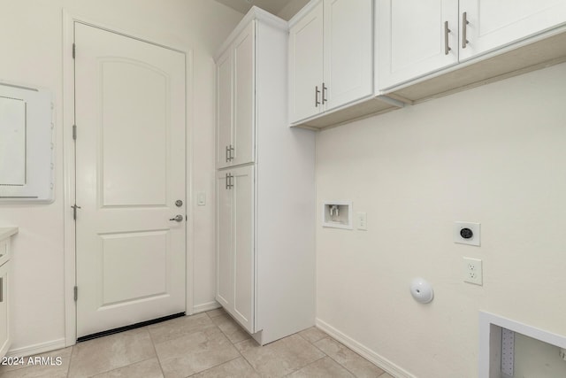 laundry area with electric dryer hookup, light tile patterned floors, hookup for a washing machine, and cabinets