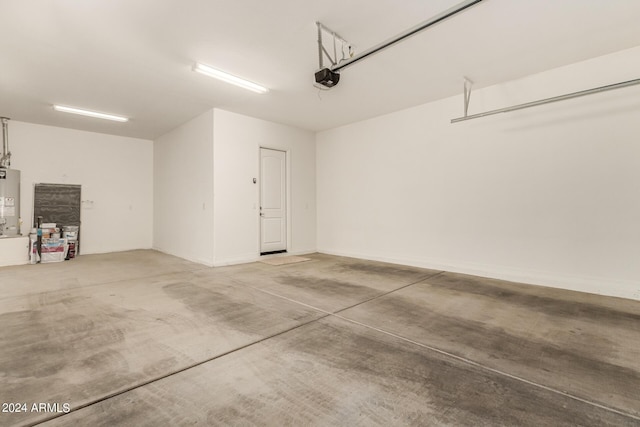 garage featuring water heater and a garage door opener