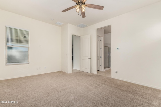 empty room featuring light carpet and ceiling fan