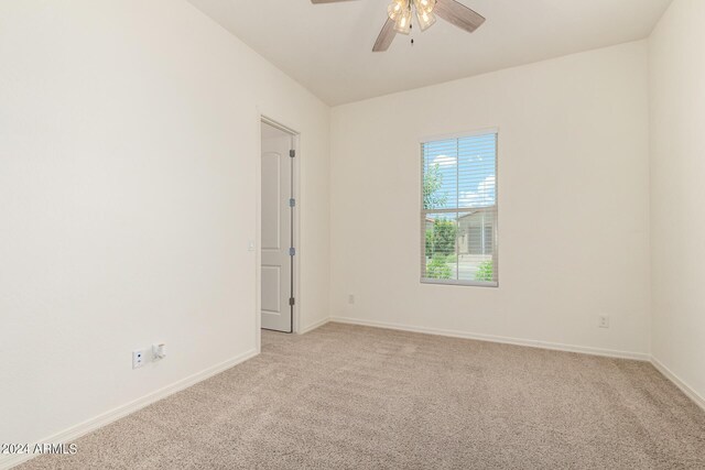 carpeted empty room featuring ceiling fan