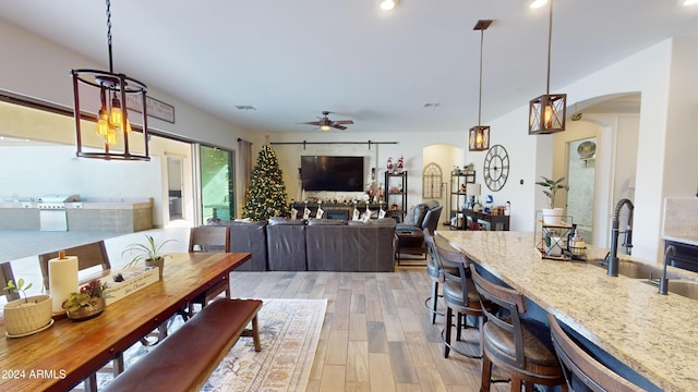 dining space featuring ceiling fan and light wood-type flooring