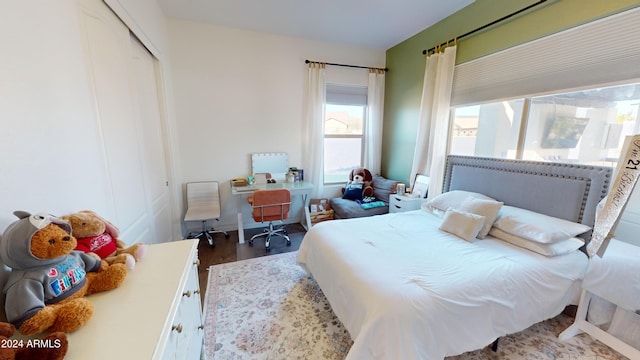 bedroom with wood-type flooring and a closet