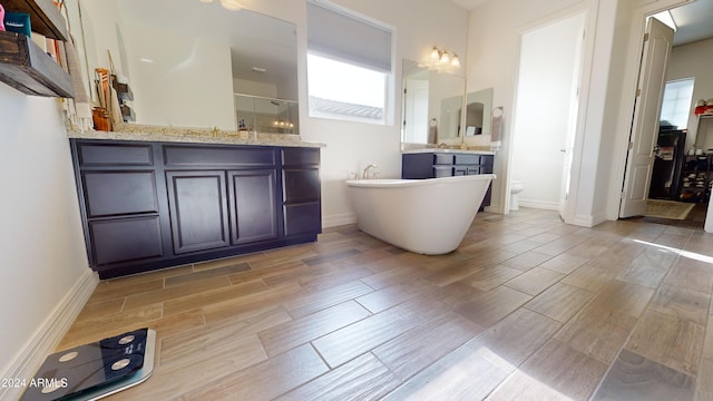 full bathroom featuring vanity, toilet, and shower with separate bathtub