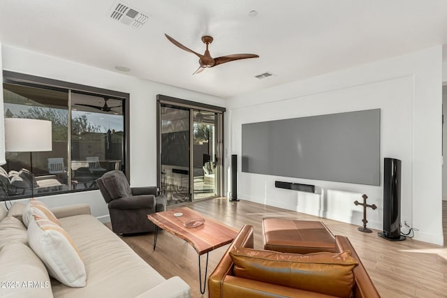 living room featuring light hardwood / wood-style floors and ceiling fan