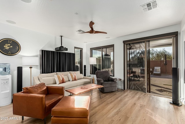 living room featuring ceiling fan and light wood-type flooring