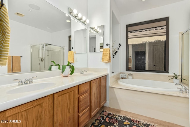 bathroom featuring vanity and separate shower and tub