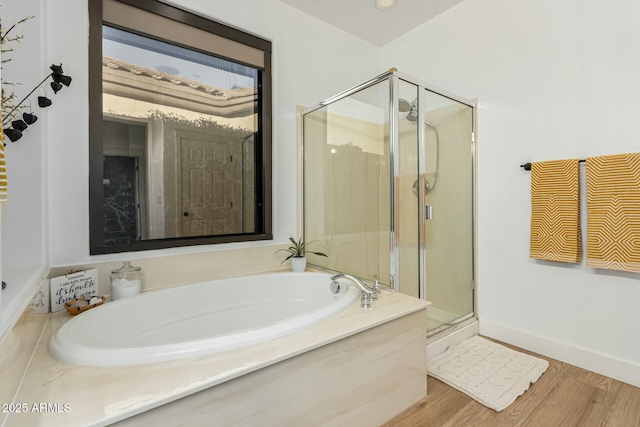 bathroom featuring independent shower and bath and hardwood / wood-style floors