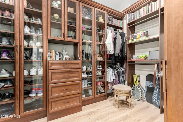 spacious closet with light hardwood / wood-style flooring