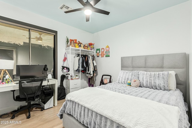 bedroom with a closet, ceiling fan, and light hardwood / wood-style flooring