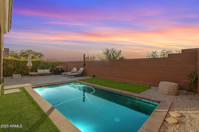 pool at dusk with a patio