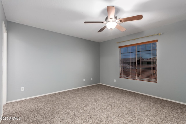 spare room featuring baseboards, carpet flooring, and a ceiling fan