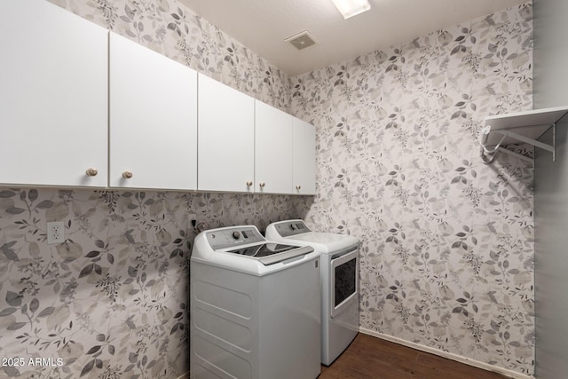 clothes washing area with cabinet space, independent washer and dryer, baseboards, dark wood-type flooring, and visible vents