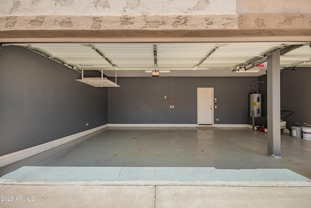 garage with baseboards and water heater