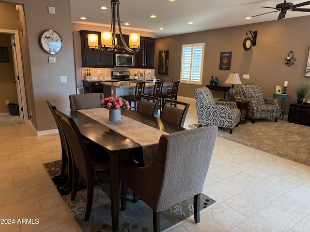 dining space featuring ceiling fan with notable chandelier