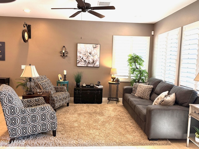 living room featuring ceiling fan and light carpet