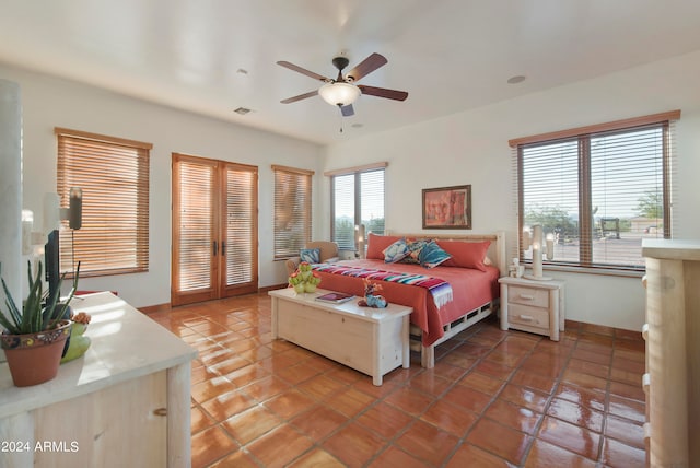 tiled bedroom featuring ceiling fan