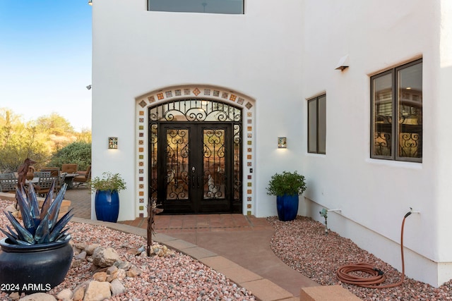 property entrance featuring french doors and a patio area