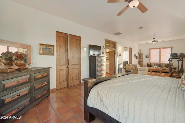 tiled bedroom with ceiling fan