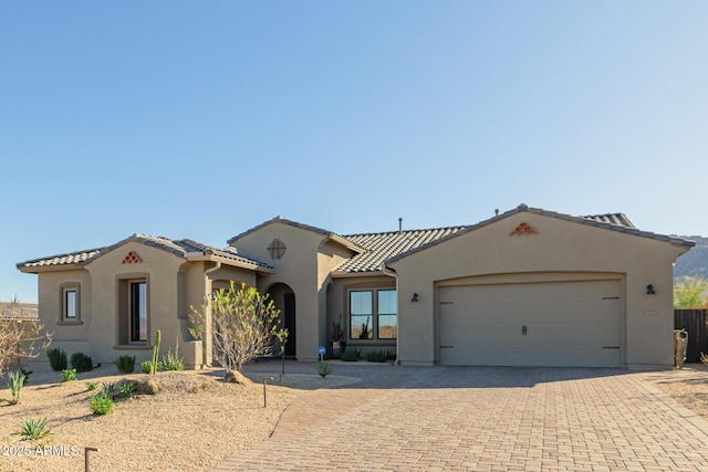 mediterranean / spanish home featuring a garage