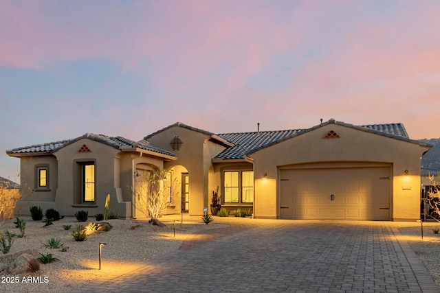 mediterranean / spanish house featuring a garage