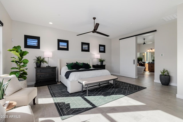 bedroom featuring ceiling fan and ensuite bath