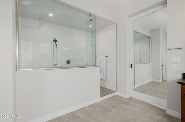 bathroom with a tile shower and tile patterned flooring