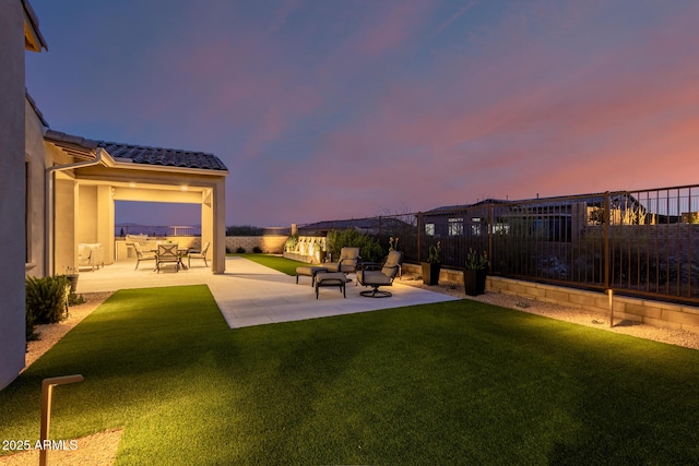 yard at dusk featuring a patio