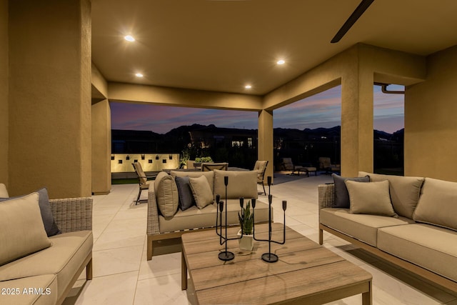 patio terrace at dusk featuring an outdoor living space