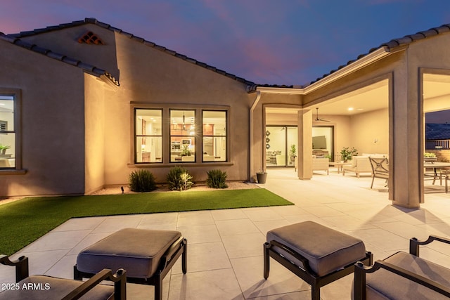 patio terrace at dusk with an outdoor living space