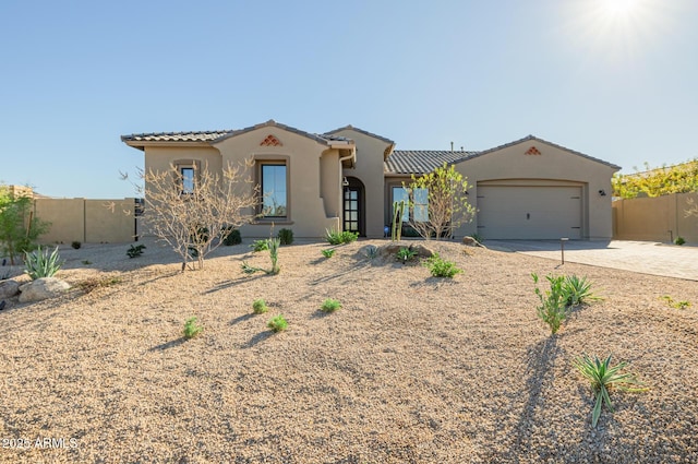 mediterranean / spanish-style home with a garage