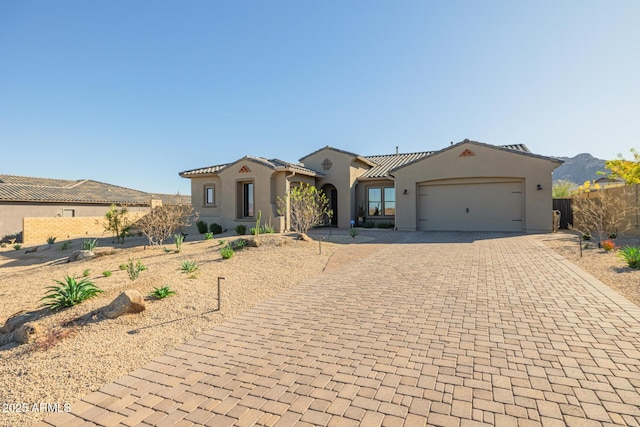 mediterranean / spanish home featuring a mountain view and a garage