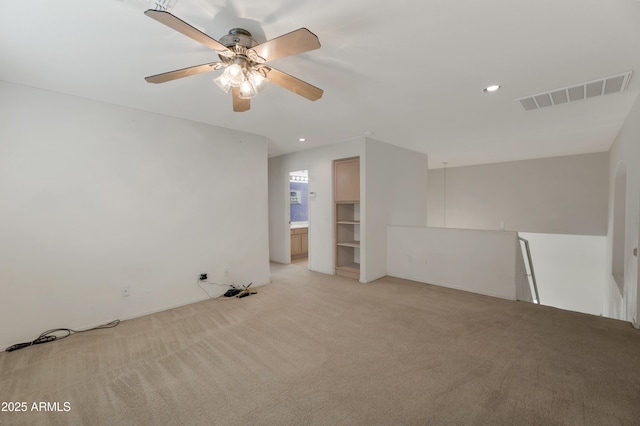 spare room featuring light colored carpet