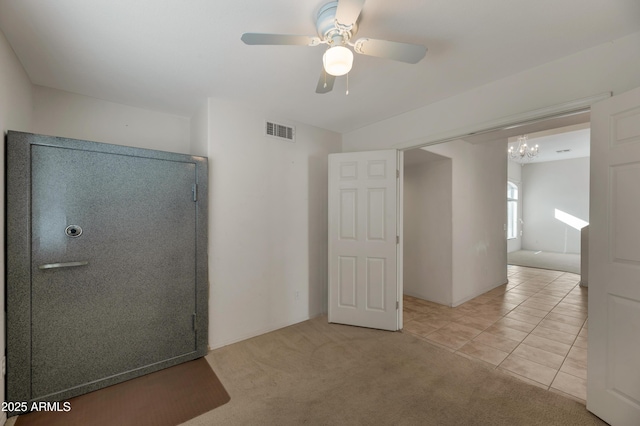 interior space with ceiling fan with notable chandelier