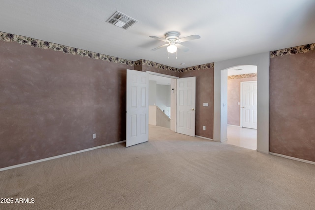 unfurnished bedroom featuring light carpet and ceiling fan