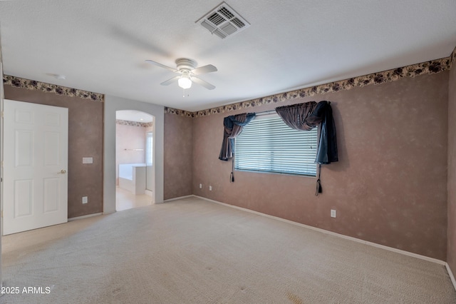 carpeted spare room with ceiling fan