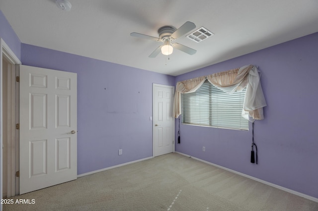 unfurnished bedroom featuring ceiling fan, a closet, and light carpet