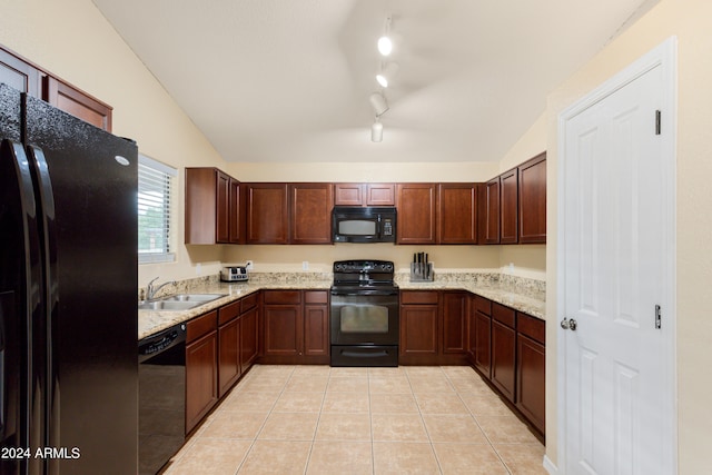 kitchen featuring lofted ceiling, black appliances, track lighting, and sink