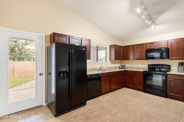 kitchen featuring lofted ceiling, sink, a healthy amount of sunlight, and black appliances