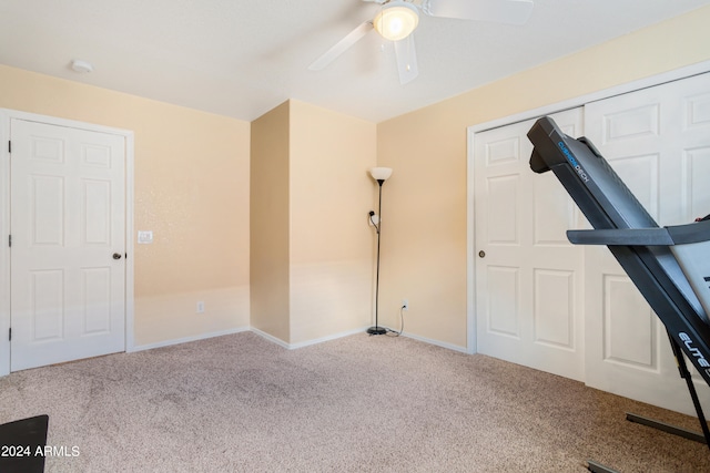 workout room featuring carpet and ceiling fan