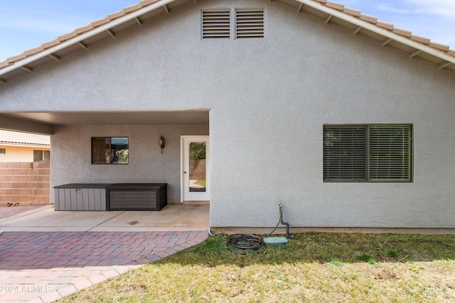 rear view of property with a lawn and a patio area