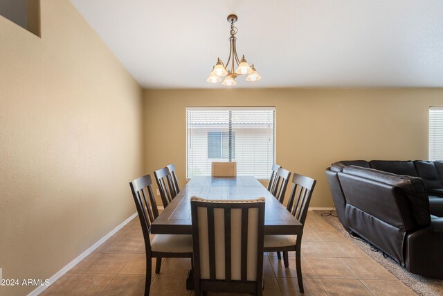 dining area with an inviting chandelier and light tile patterned floors