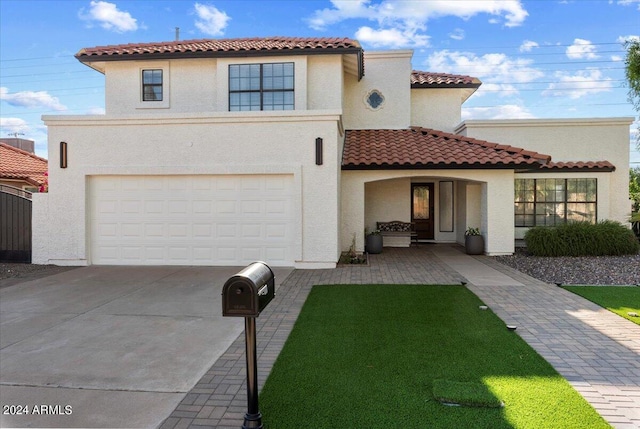 16008 N 56th Way, Scottsdale, AZ 85254 - mediterranean / spanish house featuring an attached garage, stucco siding, concrete driveway, and a tiled roof