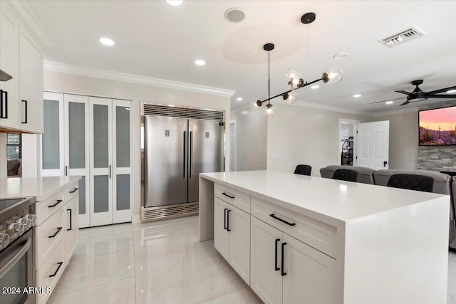 16008 N 56th Way, Scottsdale, AZ 85254 - kitchen featuring stainless steel appliances, ornamental molding, ceiling fan, hanging light fixtures, and white cabinetry