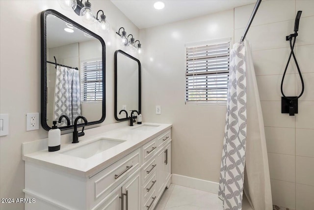 16008 N 56th Way, Scottsdale, AZ 85254 - bathroom featuring double vanity, baseboards, and a tile shower