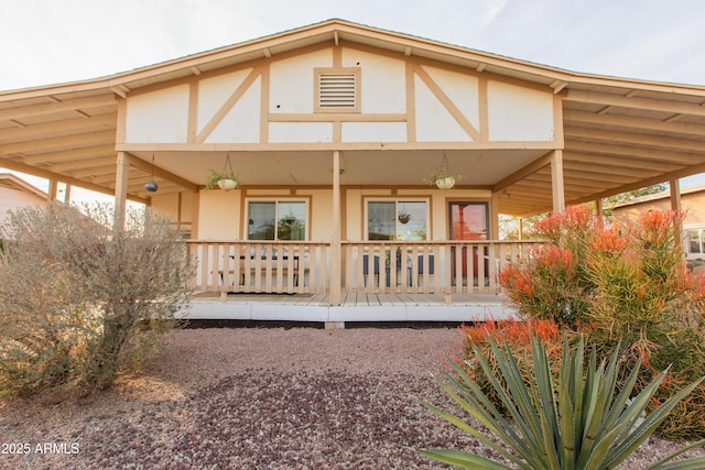 back of house featuring covered porch