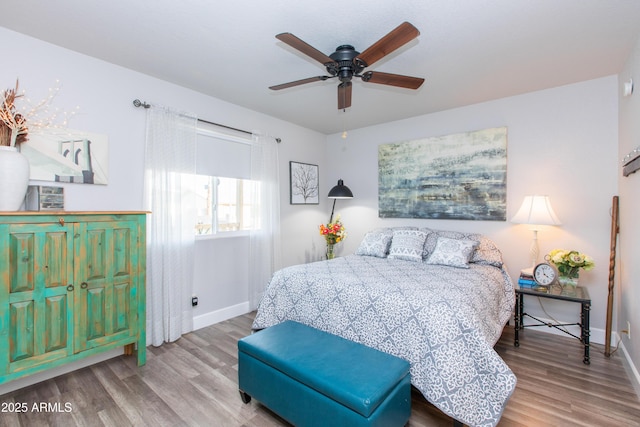 bedroom with hardwood / wood-style flooring and ceiling fan