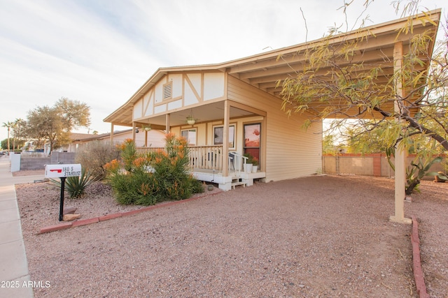 view of front of house featuring a carport and covered porch